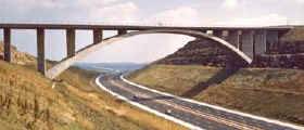 concrete bridge over a massive cutting for a motorway